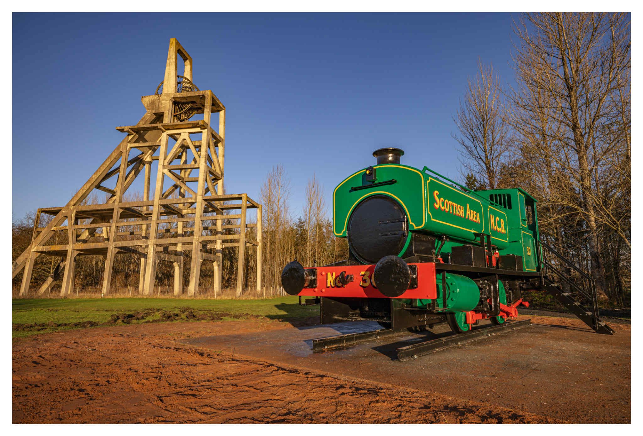 The historic pug train sitting next to the Mary Pit Wheel mining heritage site in Lochore Meadows.
